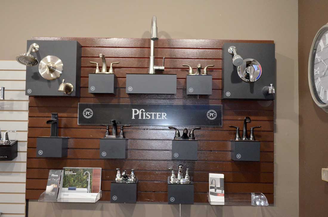 Fixture brands we install, displayed on a board, for new construction plumbing in Wake Forest, NC