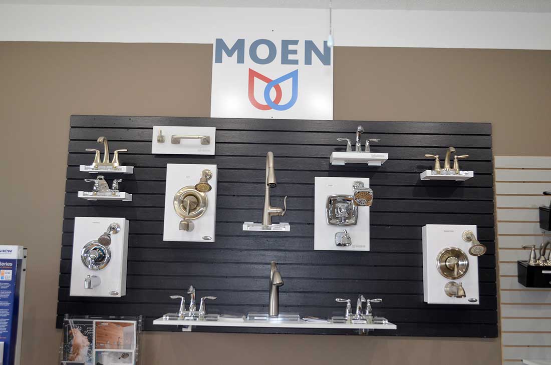 Mixer taps and faucet cartridges on a fixture display board, the kind of parts fitted during plumbing services in Wake Forest, NC