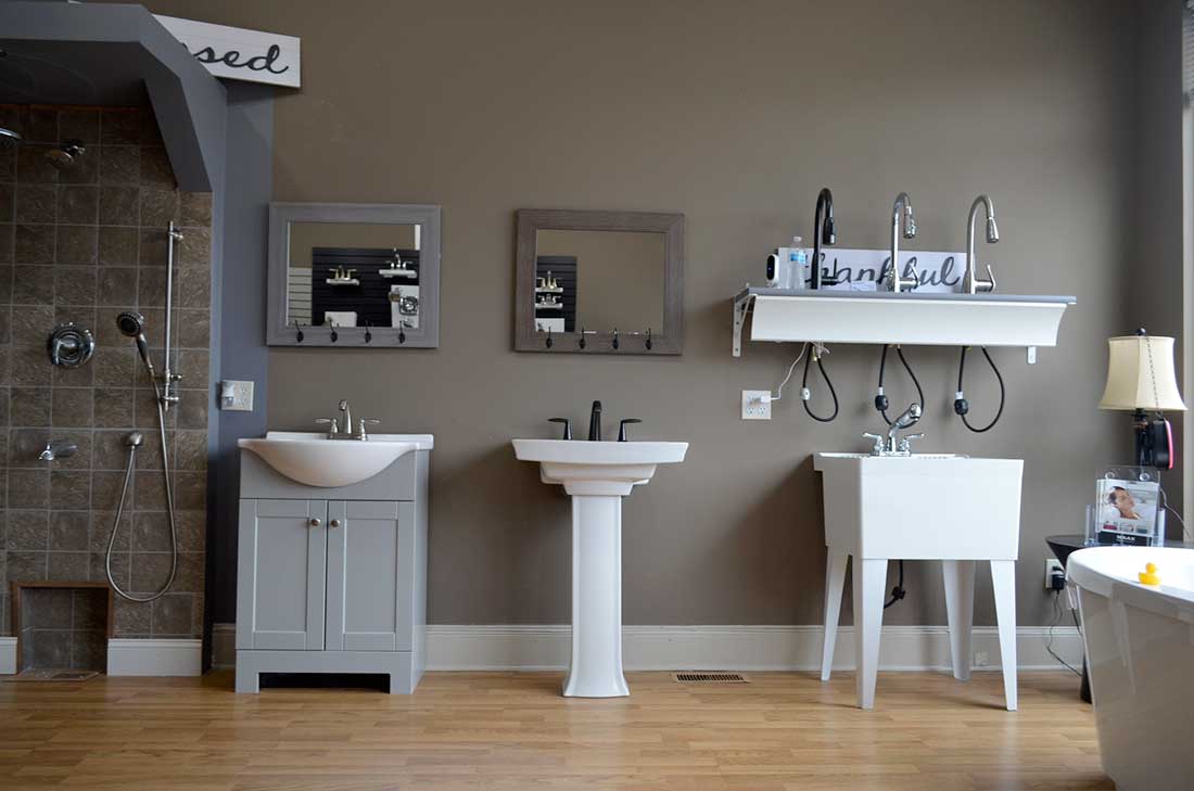Vanity and pedestal sink styles alongside a tiled shower, typical of shower, tub and sink installation in Wake Forest, NC
