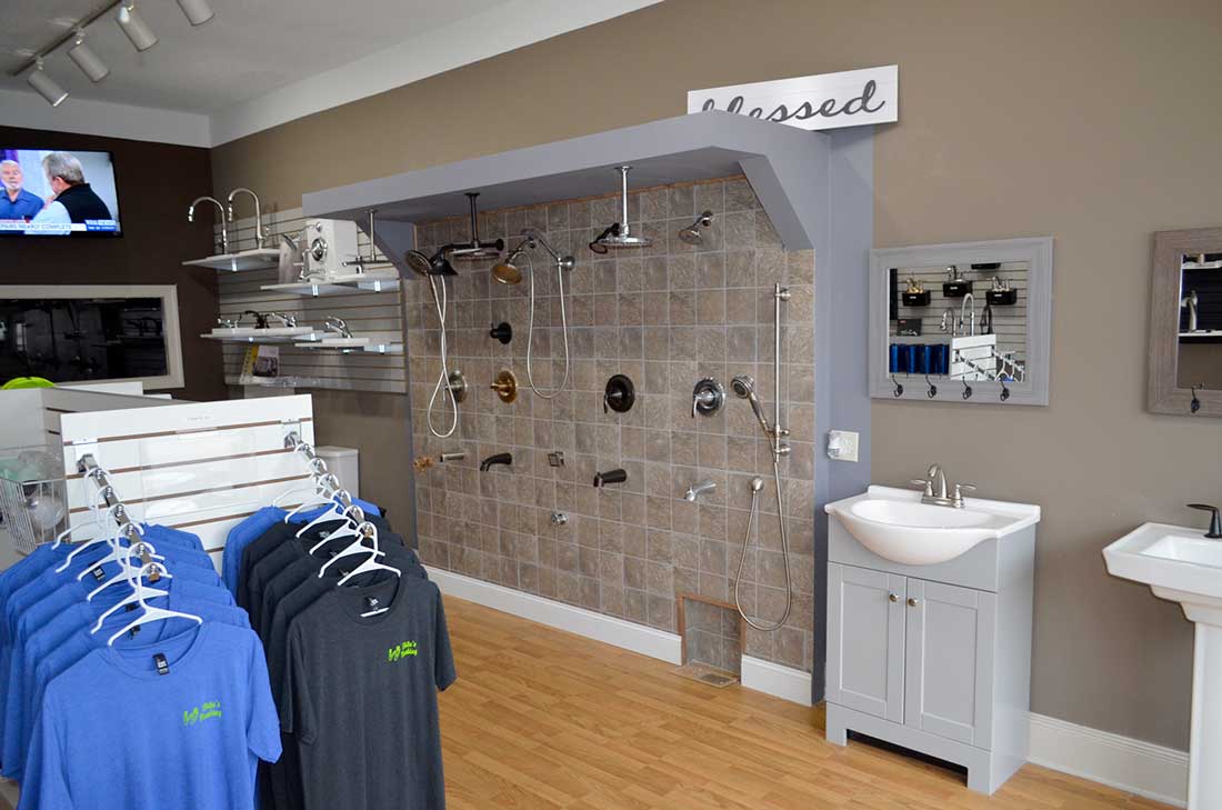White's Plumbing branded work shirts on a rack