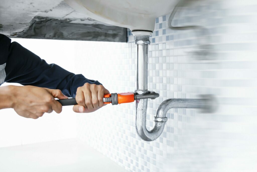 kitchen sink install Concept, Creative Photo About Plumber installing sink in kitchen interior.