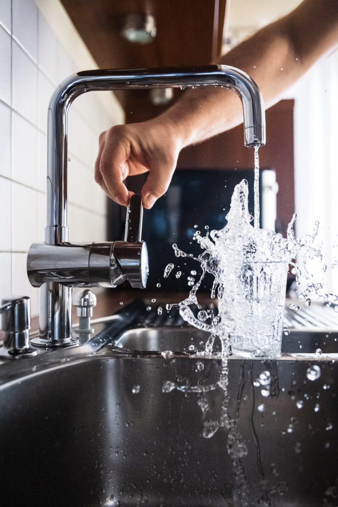 Clean water running strongly from a kitchen faucet after faucet repair in Wake Forest, NC